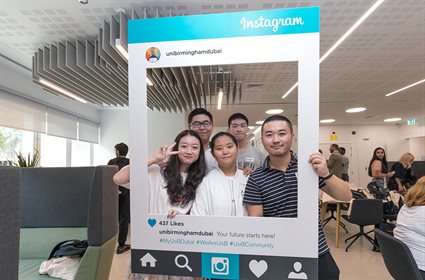 Students posing with selfie frame